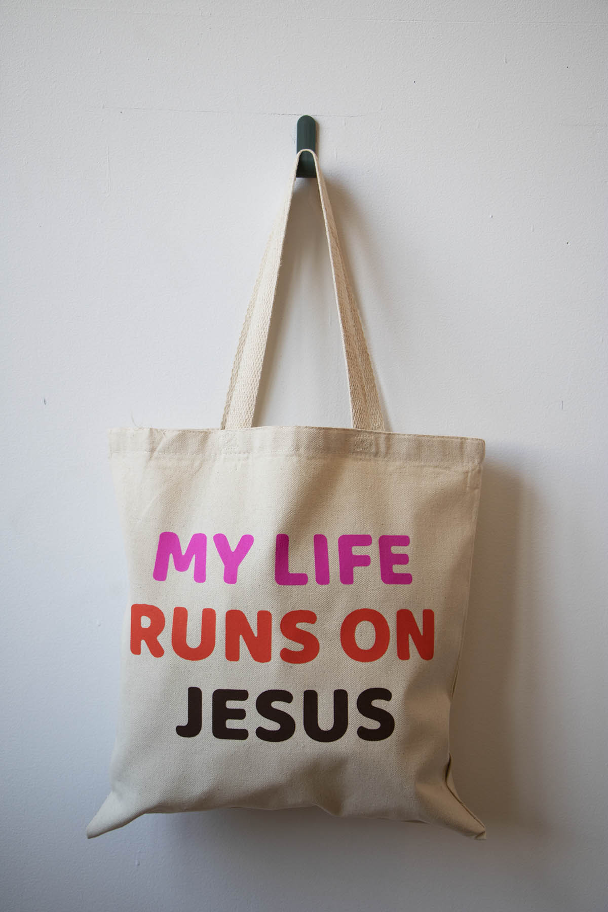 MY LIFE RUNS ON JESUS TOTE BAG.